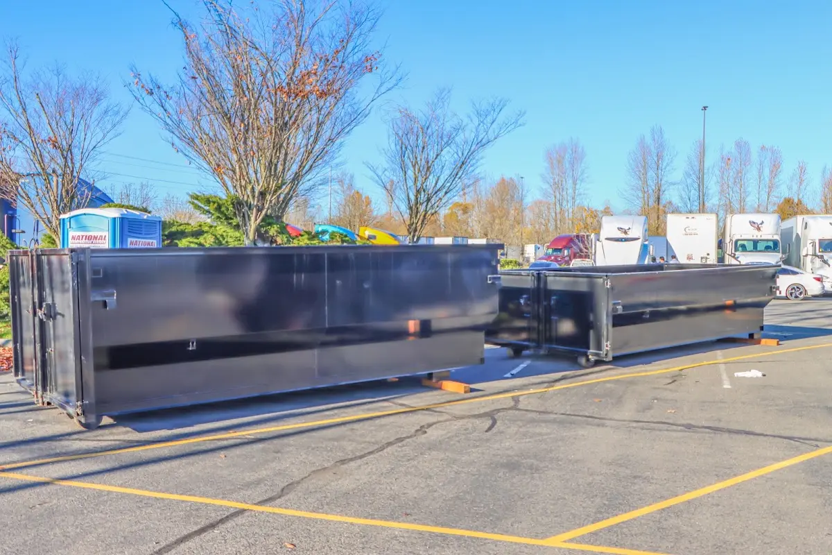 Professional dumpster rental service with roll-off container on residential driveway in Rio del Mar